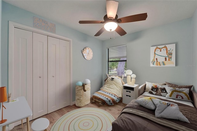 bedroom with a closet, wood finished floors, and ceiling fan