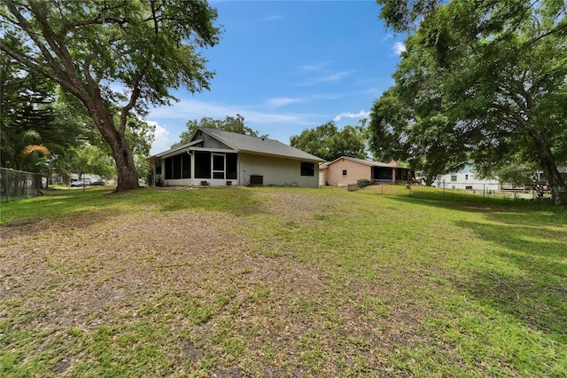 rear view of property with a sunroom