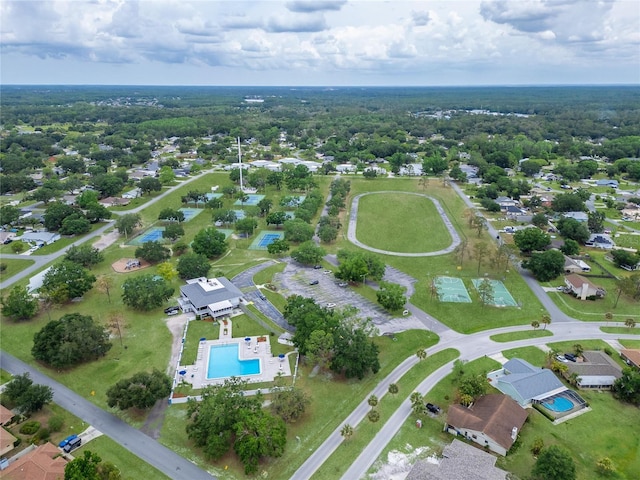 aerial view of property and surrounding area with a pool area