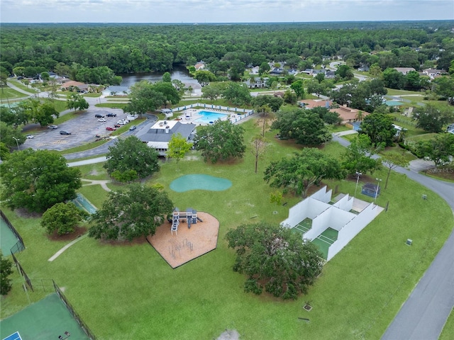 aerial view of a heavily wooded area and a pool
