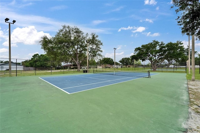 view of tennis court with fence and community basketball court