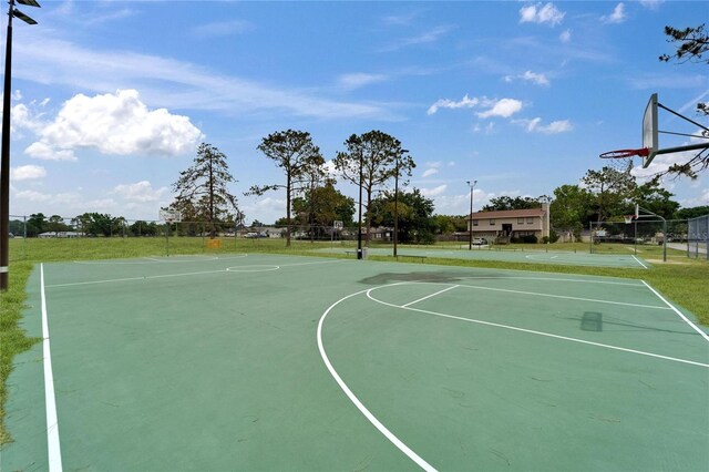 view of sport court featuring community basketball court, fence, and an area for soccer