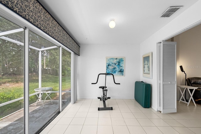 2413 Oxford Down Ct Unit 58, Sun City Center, FL 33573 - workout room featuring tile patterned flooring and baseboards