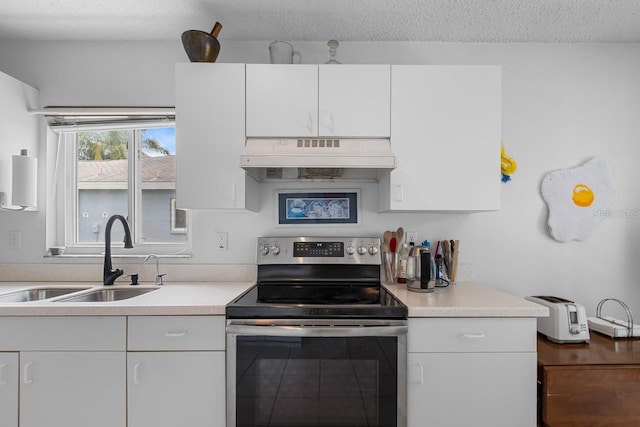 2413 Oxford Down Ct Unit 58, Sun City Center, FL 33573 - kitchen featuring electric range, under cabinet range hood, a sink, light countertops, and white cabinets