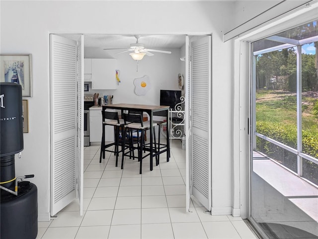 2413 Oxford Down Ct Unit 58, Sun City Center, FL 33573 - dining room featuring ceiling fan and light tile patterned floors