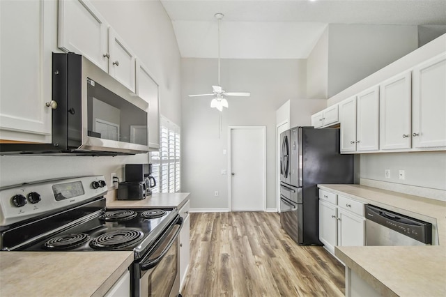 kitchen with stainless steel appliances, high vaulted ceiling, light countertops, white cabinetry, and a ceiling fan