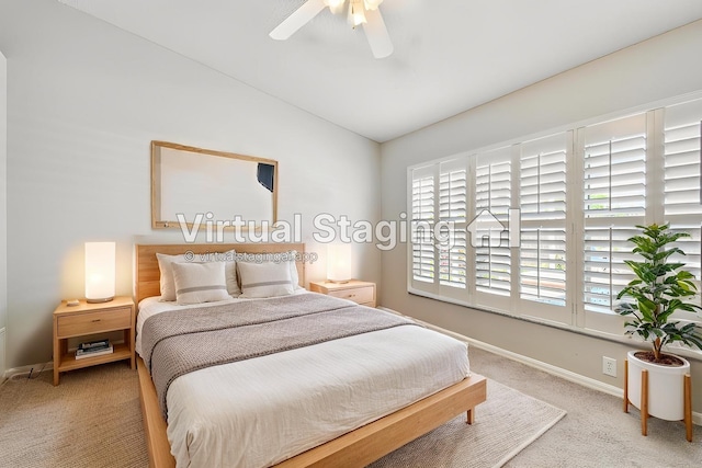 bedroom featuring light colored carpet, lofted ceiling, baseboards, and ceiling fan
