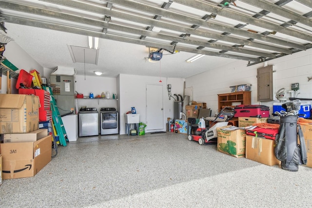 garage featuring separate washer and dryer, electric panel, a garage door opener, concrete block wall, and a sink