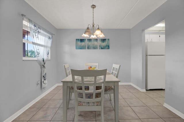 12760 Indian Rocks Rd Unit 578, Largo, FL 33774 - dining space featuring a chandelier, light tile patterned floors, and baseboards