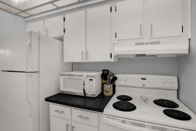 12760 Indian Rocks Rd Unit 578, Largo, FL 33774 - kitchen with white appliances, under cabinet range hood, white cabinetry, and dark countertops