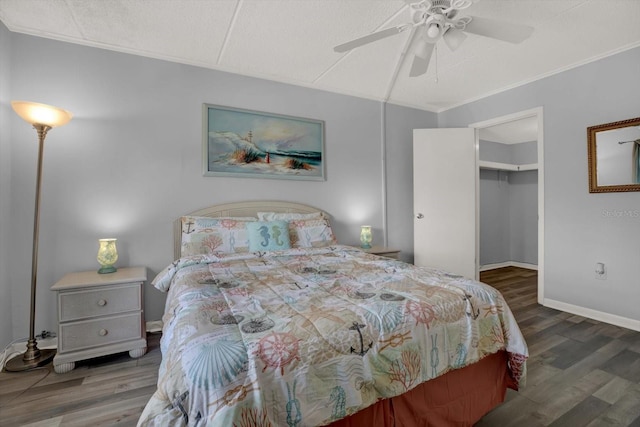 12760 Indian Rocks Rd Unit 578, Largo, FL 33774 - bedroom with wood finished floors, a walk in closet, ceiling fan, crown molding, and baseboards