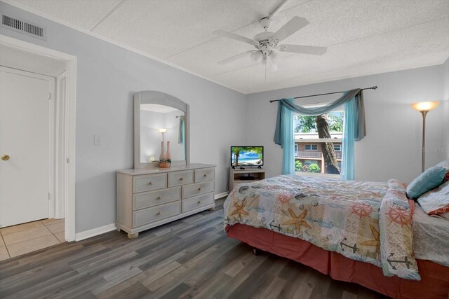 12760 Indian Rocks Rd Unit 578, Largo, FL 33774 - bedroom with arched walkways, wood finished floors, a textured ceiling, a ceiling fan, and baseboards