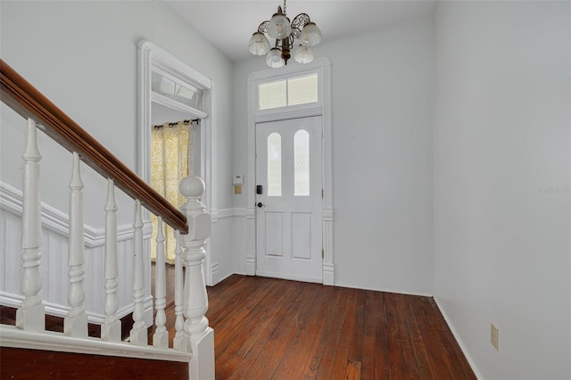 entrance foyer featuring a chandelier, wood-type flooring, and stairway