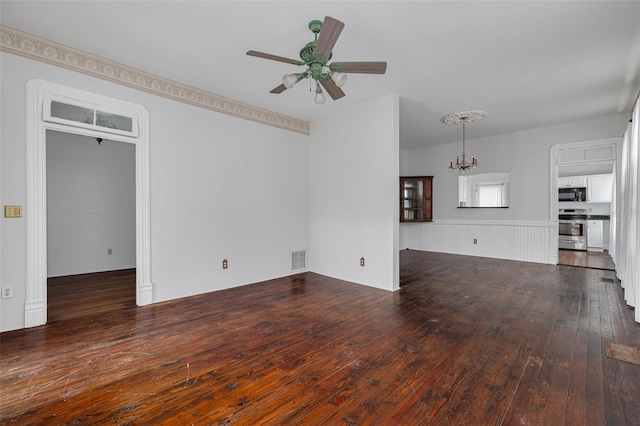 unfurnished living room with wood-type flooring, ceiling fan, and a chandelier
