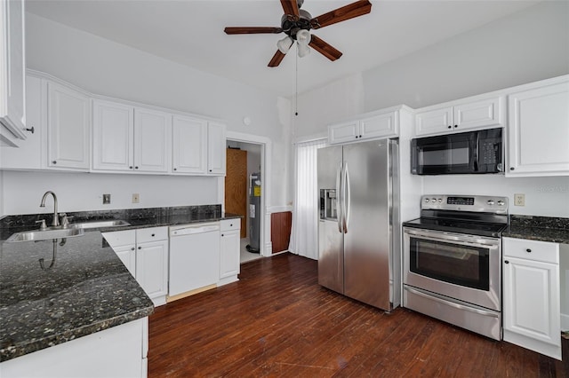 kitchen with appliances with stainless steel finishes, ceiling fan, white cabinets, dark wood-style flooring, and dark stone counters
