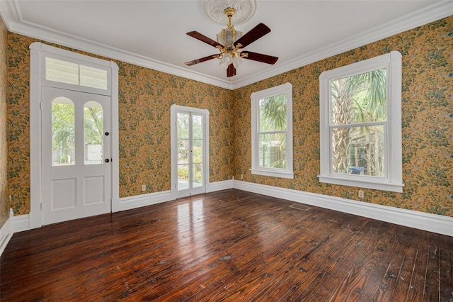 foyer entrance featuring hardwood / wood-style flooring, plenty of natural light, a ceiling fan, baseboards, and crown molding