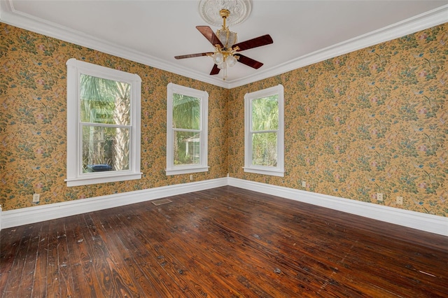 unfurnished room featuring wood-type flooring, a ceiling fan, baseboards, and ornamental molding