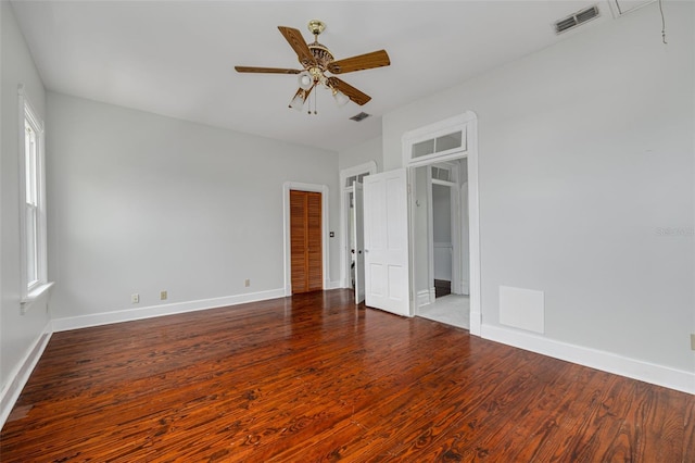 unfurnished bedroom with wood finished floors, baseboards, ceiling fan, and a closet