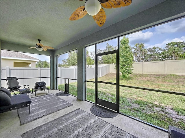 sunroom / solarium featuring ceiling fan