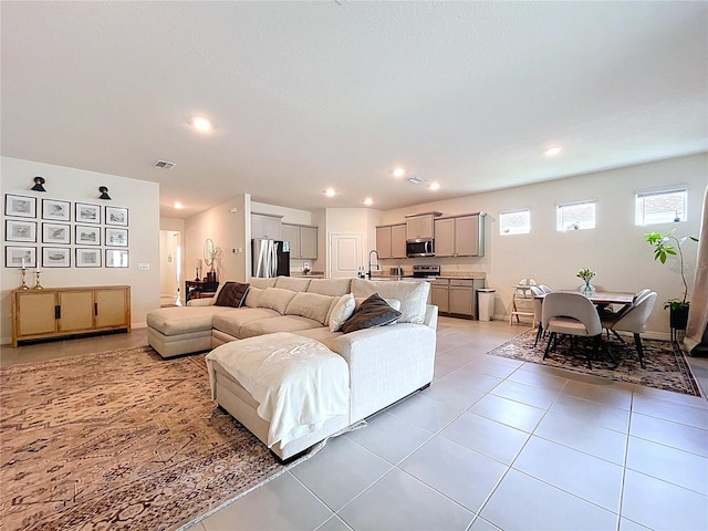 living area featuring light tile patterned floors, recessed lighting, and baseboards