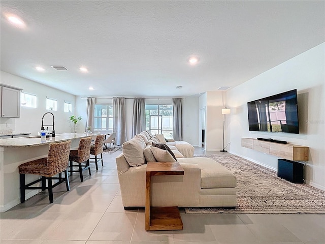 living area with recessed lighting, baseboards, and light tile patterned floors