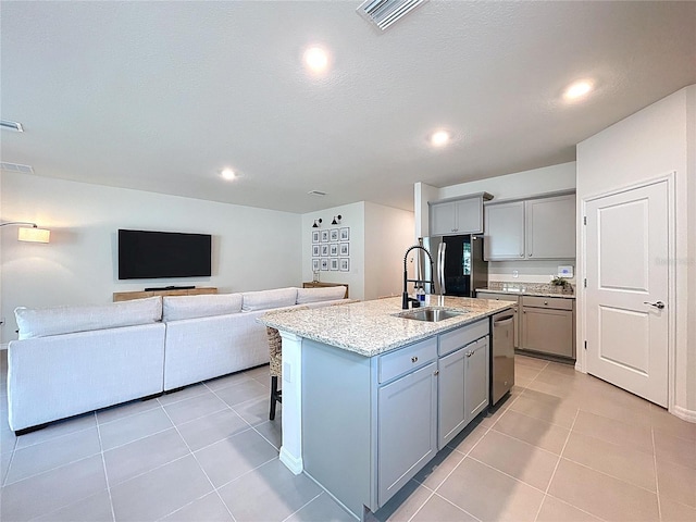kitchen featuring gray cabinets, a sink, stainless steel dishwasher, light tile patterned floors, and recessed lighting