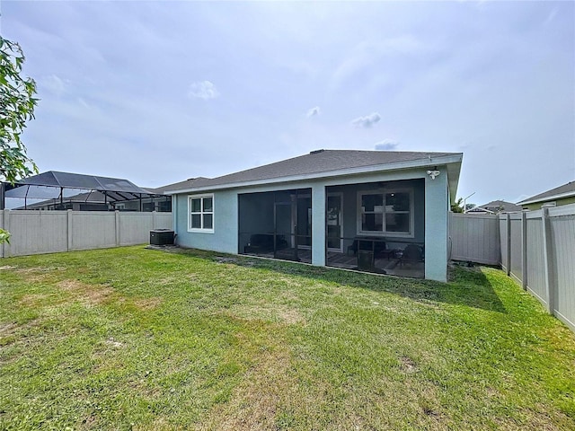 back of property with cooling unit, a sunroom, and stucco siding
