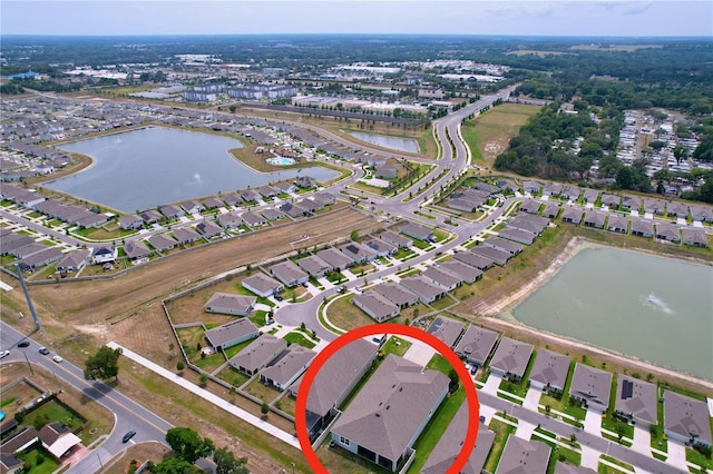 aerial overview of property's location with a large body of water and nearby suburban area