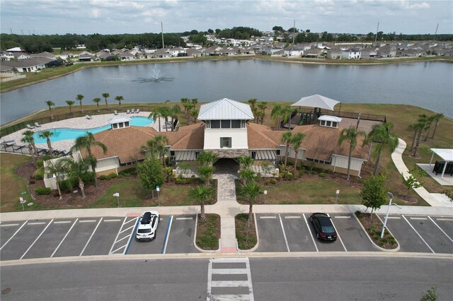 aerial view of a pool area and a large body of water