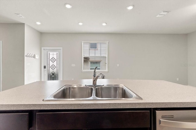 kitchen featuring a sink, dishwasher, recessed lighting, and light countertops