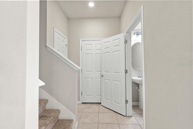 stairs with tile patterned floors and baseboards