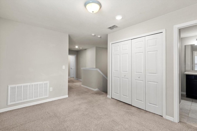 below grade area featuring light colored carpet, baseboards, and recessed lighting