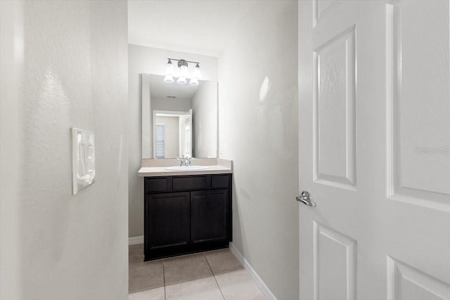 bathroom featuring tile patterned floors, baseboards, and vanity