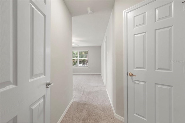 corridor featuring carpet and baseboards