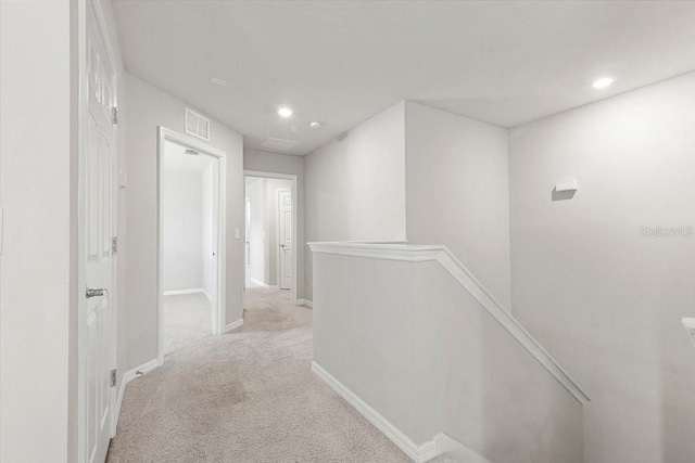 corridor with an upstairs landing, carpet floors, recessed lighting, and baseboards