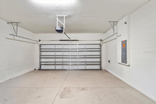 garage with a garage door opener, electric panel, and concrete block wall