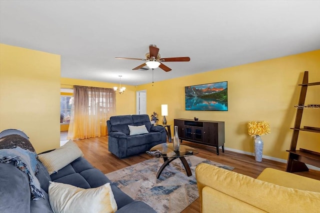 1453 62nd Ter S, Saint Petersburg, FL 33705 - living room featuring wood finished floors, a ceiling fan, and baseboards