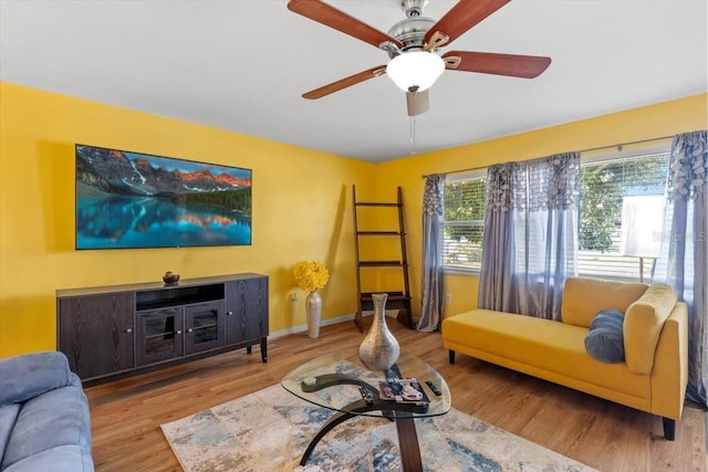 1453 62nd Ter S, Saint Petersburg, FL 33705 - living room featuring wood finished floors, a ceiling fan, and baseboards