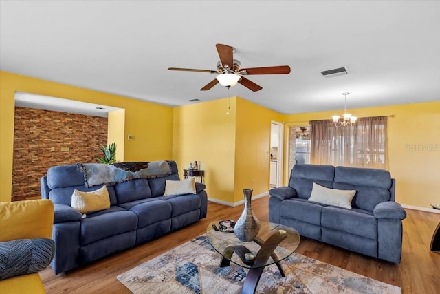 1453 62nd Ter S, Saint Petersburg, FL 33705 - living area with ceiling fan, a chandelier, and wood finished floors