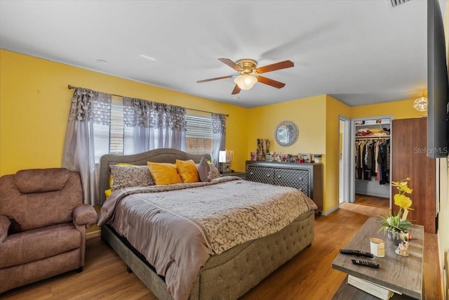 1453 62nd Ter S, Saint Petersburg, FL 33705 - bedroom with wood finished floors, a ceiling fan, a spacious closet, and a closet