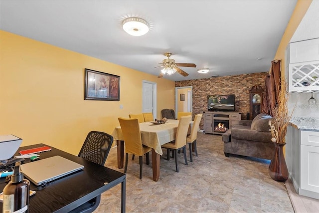 1453 62nd Ter S, Saint Petersburg, FL 33705 - dining space featuring ceiling fan and a warm lit fireplace