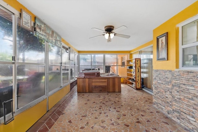 1453 62nd Ter S, Saint Petersburg, FL 33705 - sunroom / solarium with a ceiling fan and stone flooring