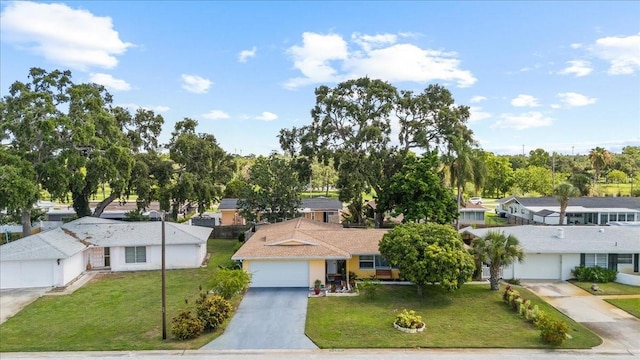 1453 62nd Ter S, Saint Petersburg, FL 33705 - view of front of home featuring driveway, a residential view, and a front yard