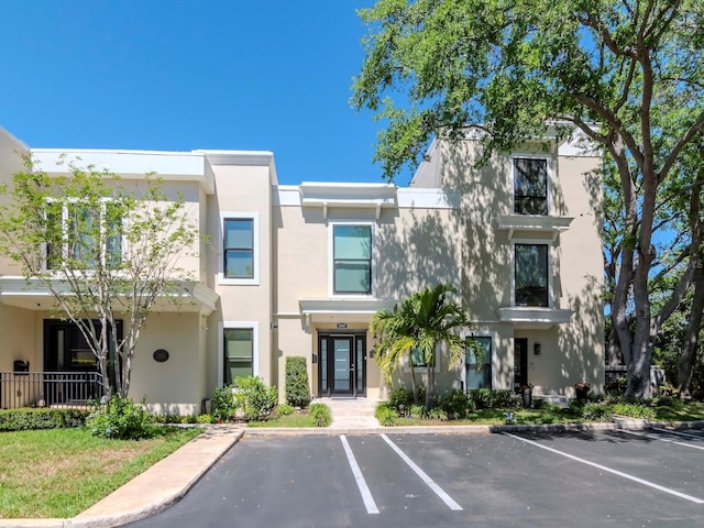 2807 W Hawthorne Rd Unit 11, Tampa, FL 33611 - view of front of home with uncovered parking and stucco siding