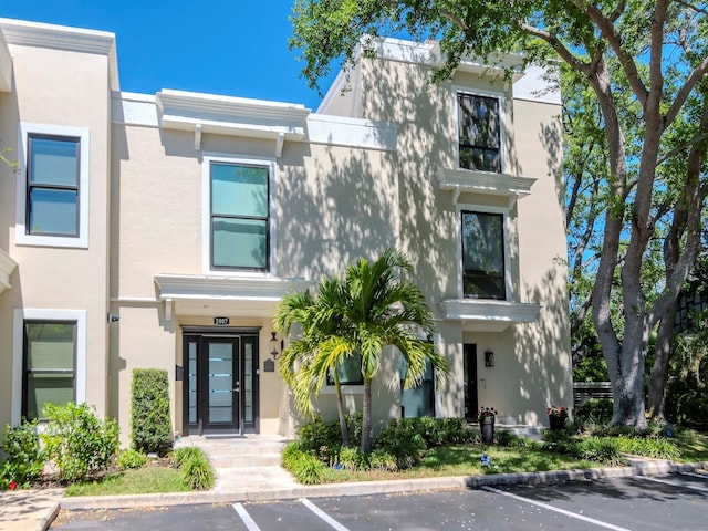 2807 W Hawthorne Rd Unit 11, Tampa, FL 33611 - view of property with uncovered parking and stucco siding