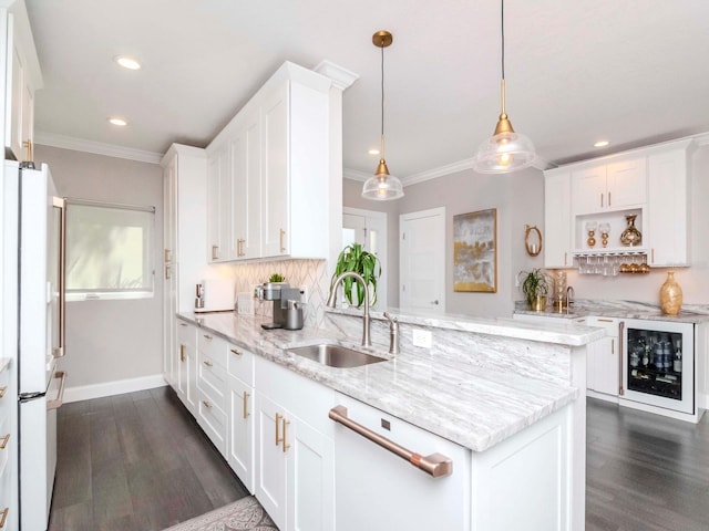 2807 W Hawthorne Rd Unit 11, Tampa, FL 33611 - kitchen with a sink, beverage cooler, white appliances, white cabinets, and a peninsula