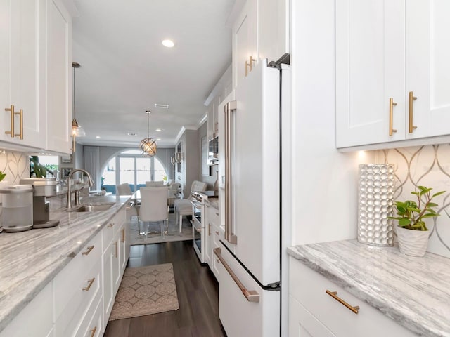 2807 W Hawthorne Rd Unit 11, Tampa, FL 33611 - kitchen featuring a sink, high end appliances, recessed lighting, white cabinets, and open floor plan