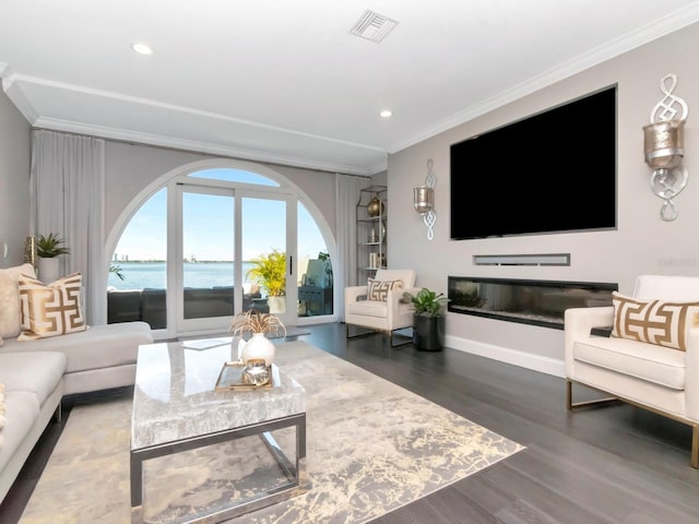 2807 W Hawthorne Rd Unit 11, Tampa, FL 33611 - living area featuring crown molding, wood finished floors, recessed lighting, baseboards, and a glass covered fireplace