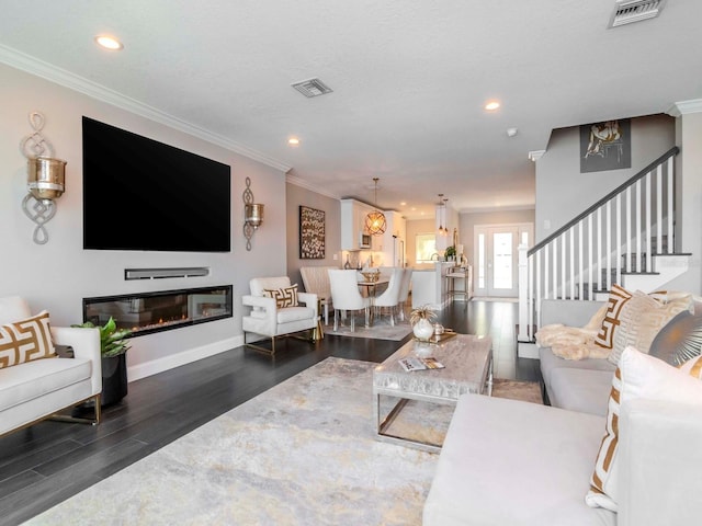 2807 W Hawthorne Rd Unit 11, Tampa, FL 33611 - living area featuring wood finished floors, ornamental molding, recessed lighting, stairs, and a glass covered fireplace