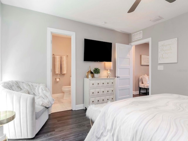 2807 W Hawthorne Rd Unit 11, Tampa, FL 33611 - bedroom featuring dark wood-style floors, ensuite bathroom, baseboards, and a ceiling fan